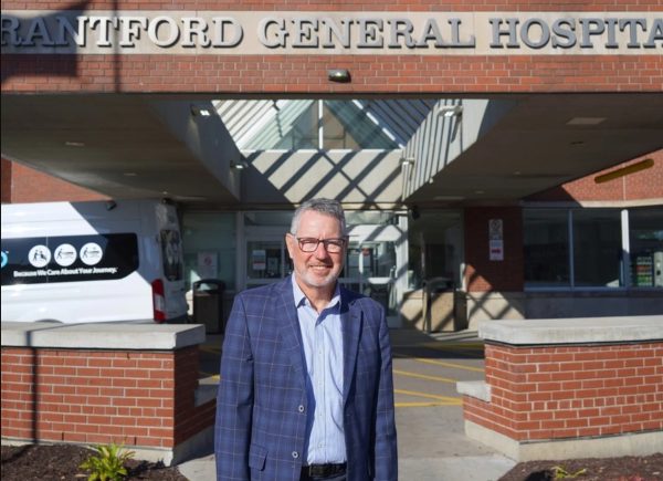 Don Shilton, Chair of the independent Site Identification Task Force, stands in front of the A-Wing entrance at the Brantford General Hospital for a quick photo.